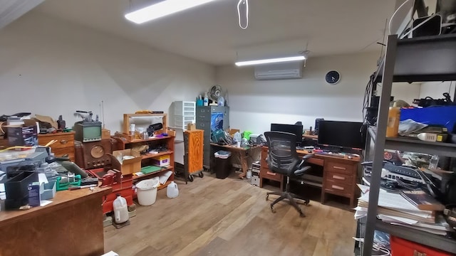 office area featuring a wall mounted air conditioner and light hardwood / wood-style flooring