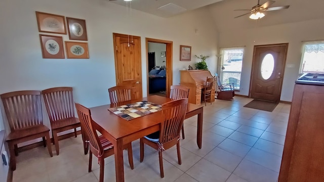 tiled dining space featuring plenty of natural light, ceiling fan, and high vaulted ceiling