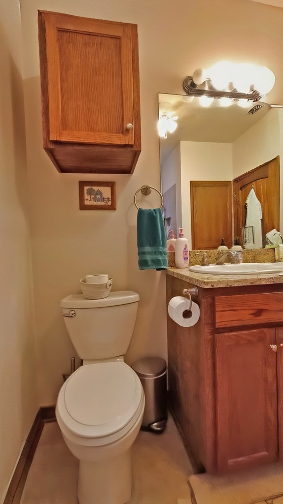 bathroom featuring vanity and toilet