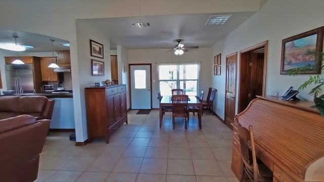 tiled dining space featuring ceiling fan