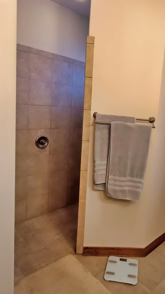 bathroom featuring tile patterned floors and a tile shower