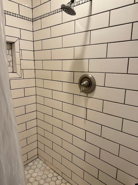 bathroom with a tile shower