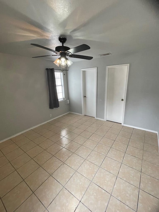 unfurnished bedroom featuring ceiling fan and light tile patterned floors