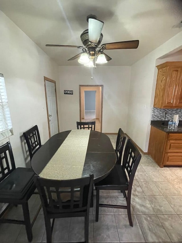 dining space featuring light tile patterned flooring and ceiling fan