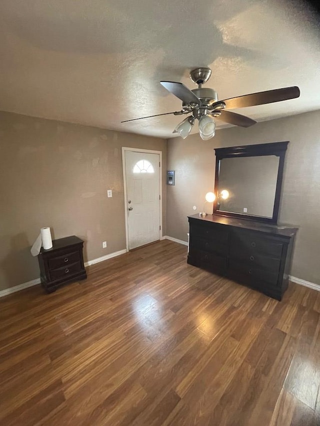 entryway featuring a textured ceiling, dark wood-type flooring, and ceiling fan