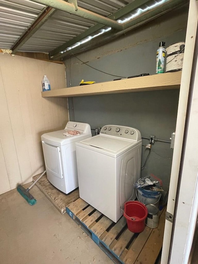 clothes washing area with washer and clothes dryer