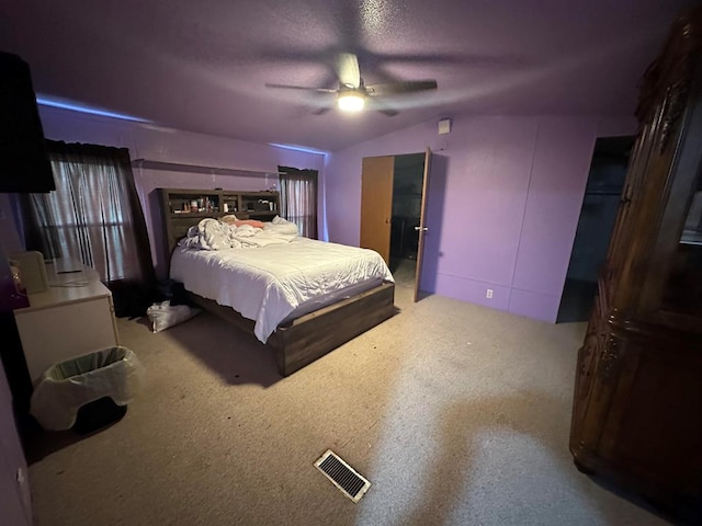 bedroom featuring a textured ceiling, ceiling fan, and lofted ceiling