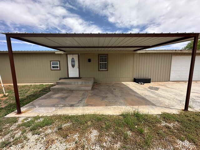 view of front of property featuring a garage and a carport