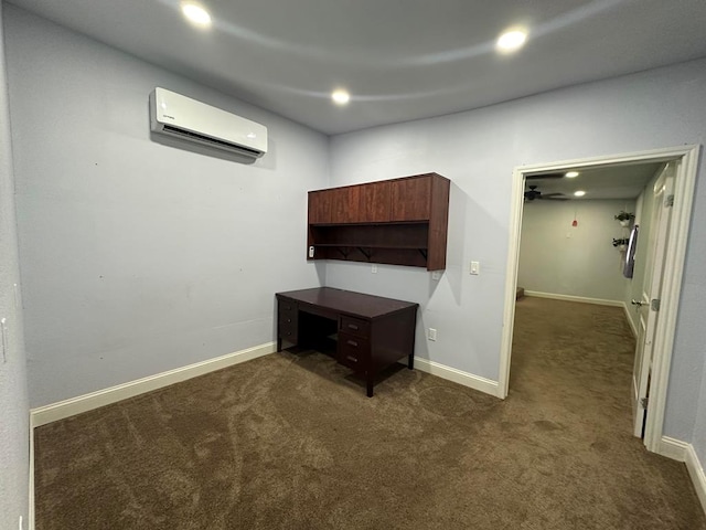 unfurnished office with a wall mounted air conditioner and dark colored carpet