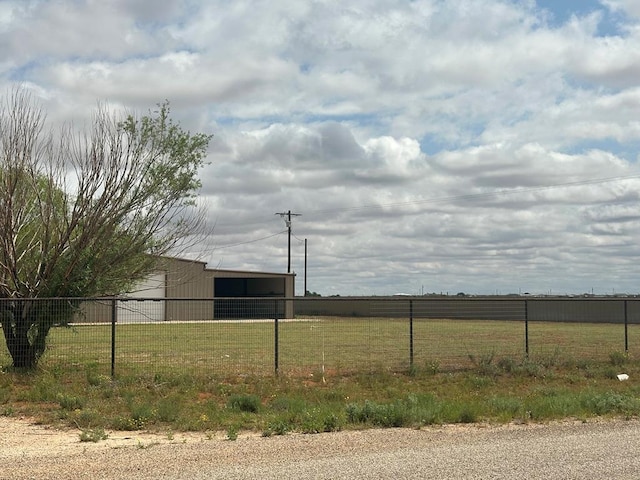 view of yard with an outbuilding and a rural view