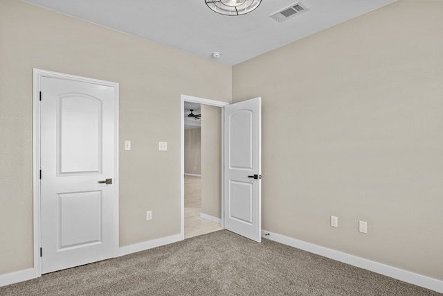 unfurnished bedroom featuring light carpet