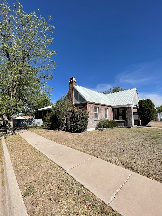 view of property exterior with a lawn