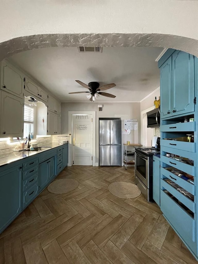 kitchen featuring blue cabinetry, light parquet flooring, stainless steel appliances, and sink