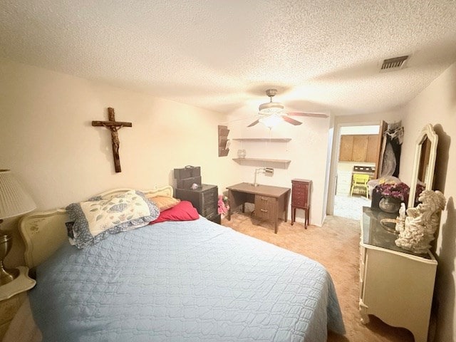 carpeted bedroom featuring visible vents, a textured ceiling, and ceiling fan