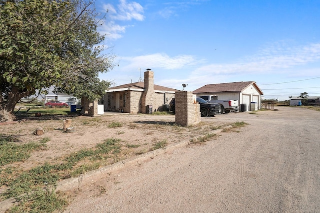 exterior space with an outbuilding and a garage