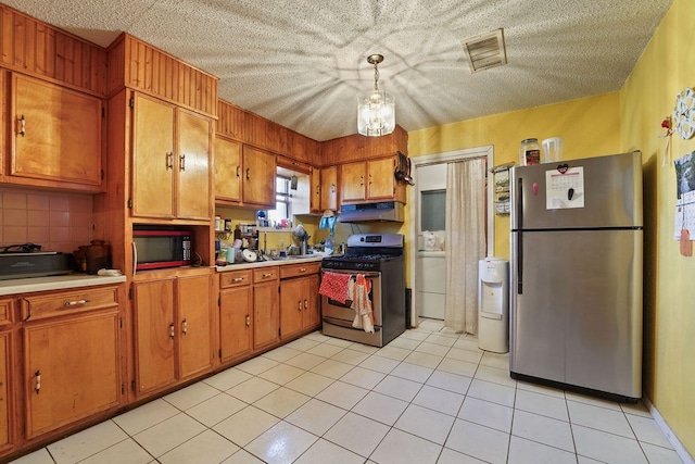 kitchen featuring light tile patterned floors, backsplash, stainless steel appliances, and hanging light fixtures