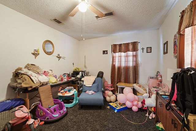 bedroom with carpet flooring, ceiling fan, and a textured ceiling