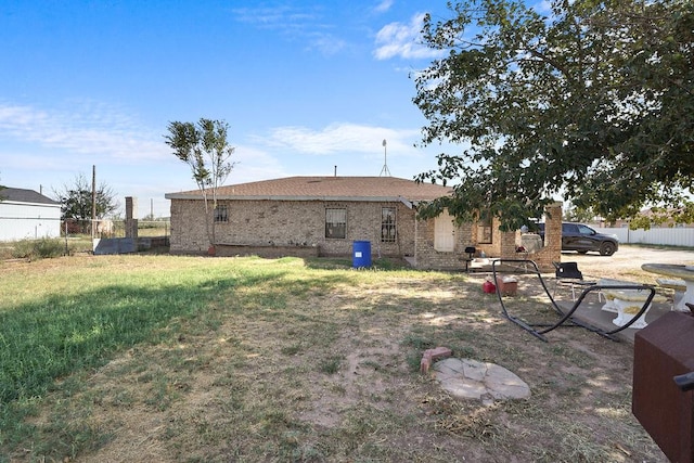 rear view of property with a yard