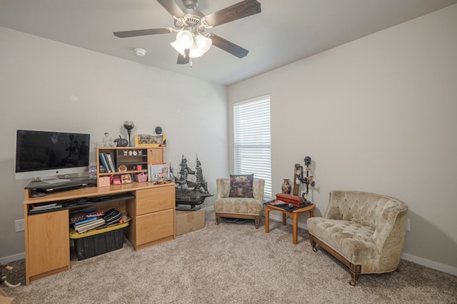 office space with baseboards, light colored carpet, and ceiling fan