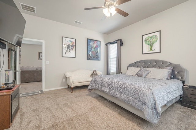 carpeted bedroom with visible vents, baseboards, and a ceiling fan