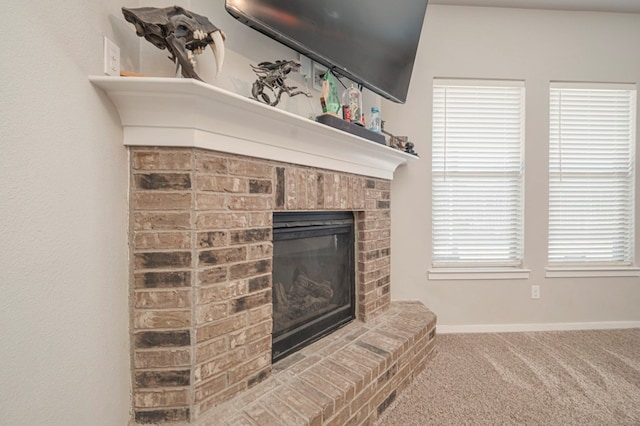 interior details with a brick fireplace, carpet, and baseboards