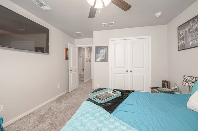 carpeted bedroom featuring a closet, visible vents, ceiling fan, and baseboards