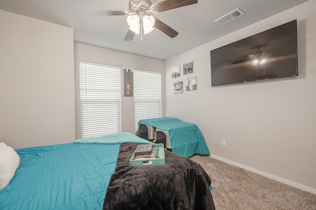 carpeted bedroom with baseboards, visible vents, and ceiling fan