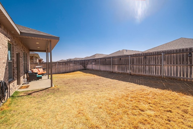 view of yard with a patio area and a fenced backyard