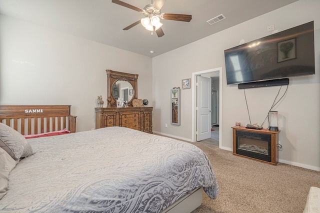 carpeted bedroom featuring baseboards, visible vents, and ceiling fan