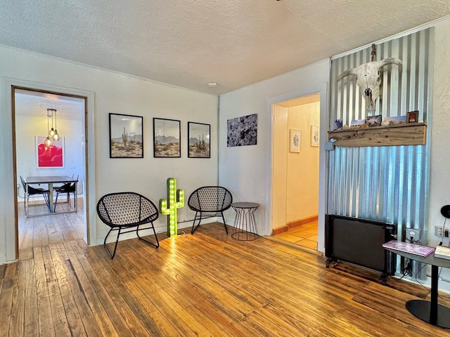 sitting room featuring hardwood / wood-style floors and a textured ceiling