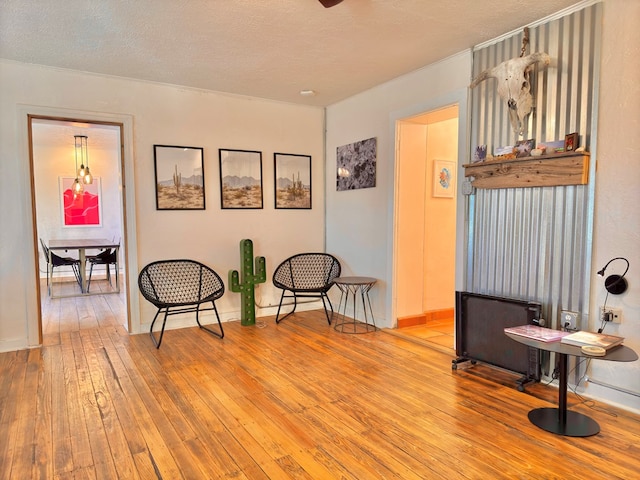 living area featuring hardwood / wood-style flooring and a textured ceiling