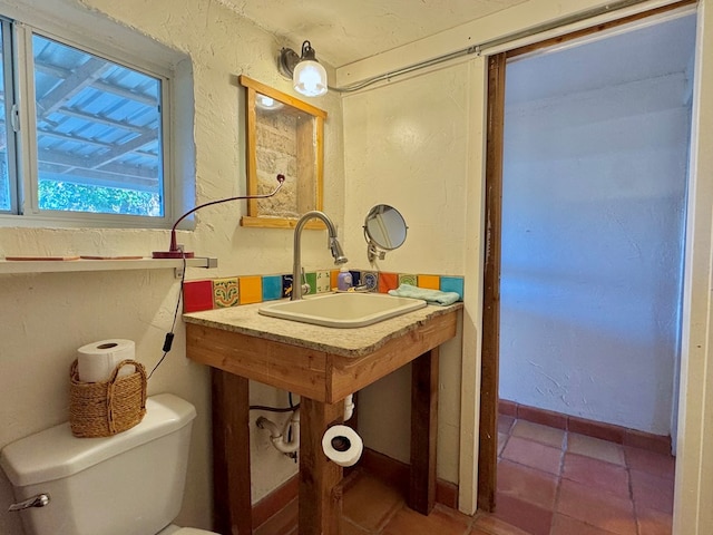 bathroom with tile patterned floors, toilet, and sink