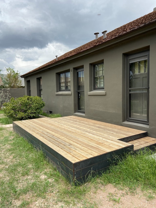 rear view of house featuring a deck