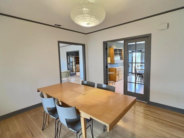 dining room featuring wood-type flooring and french doors