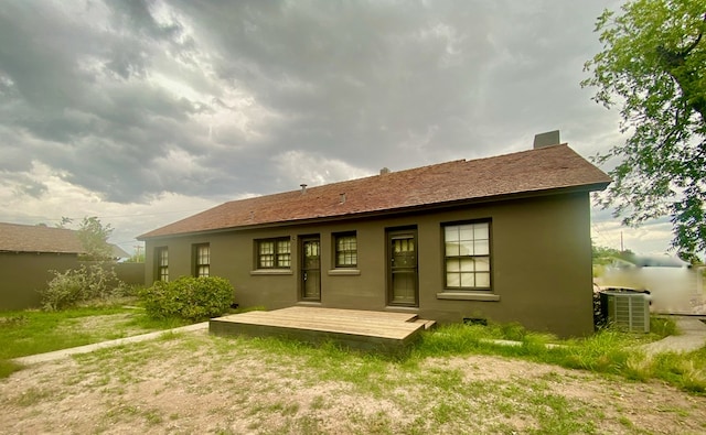 rear view of property featuring central AC unit