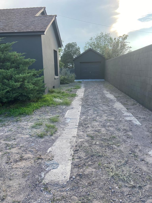 view of side of home with a garage and an outdoor structure