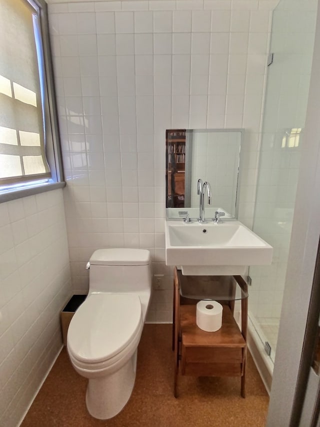 bathroom featuring tile walls and toilet