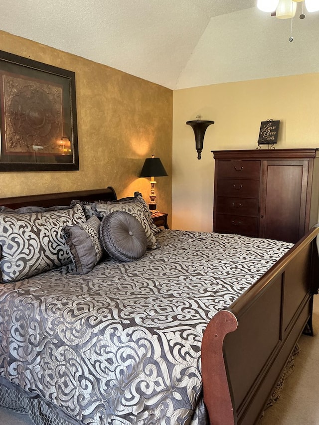 bedroom with lofted ceiling and a textured ceiling