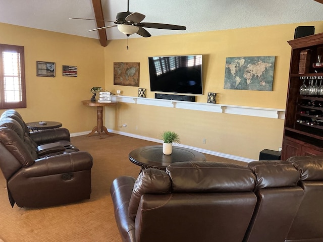 living room featuring baseboards, carpet, ceiling fan, and a textured ceiling