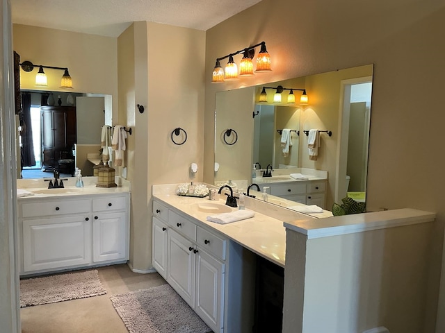 bathroom featuring a sink and two vanities