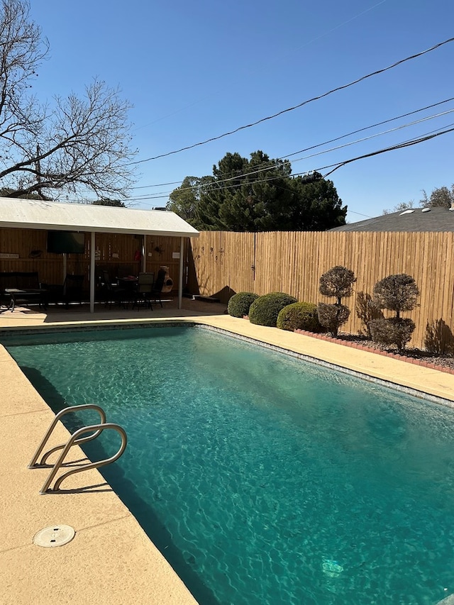 view of swimming pool featuring a patio, a fenced in pool, and fence