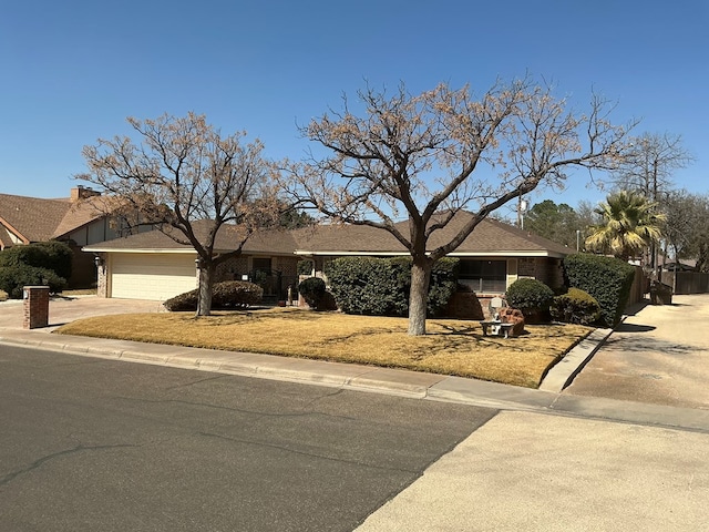 single story home with an attached garage and concrete driveway