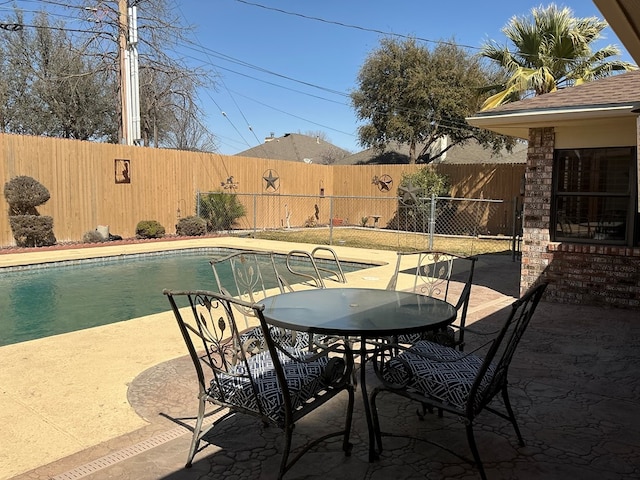 view of pool with a patio area, a fenced in pool, outdoor dining area, and a fenced backyard