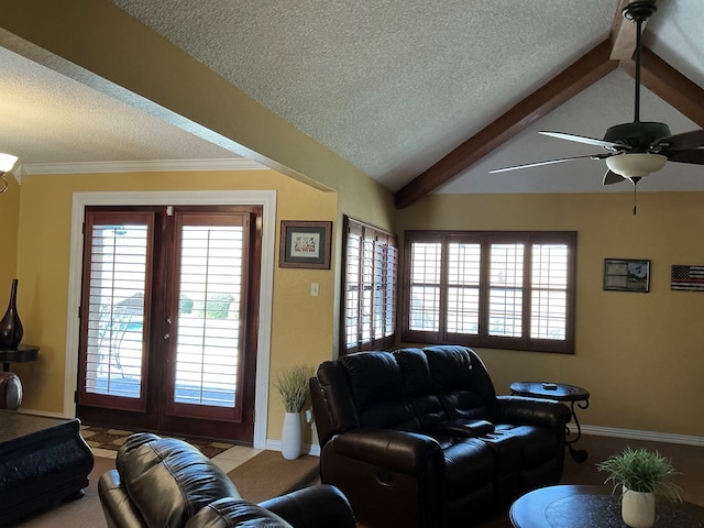 living room with lofted ceiling with beams, a wealth of natural light, and a textured ceiling