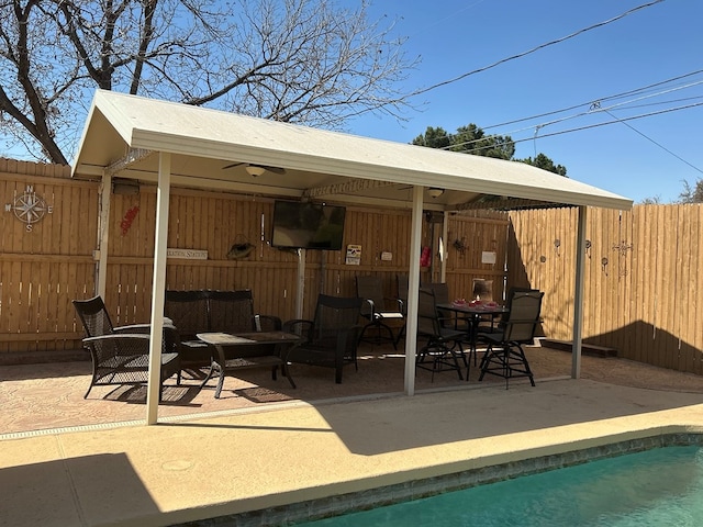 view of patio with a fenced in pool, outdoor lounge area, and a fenced backyard