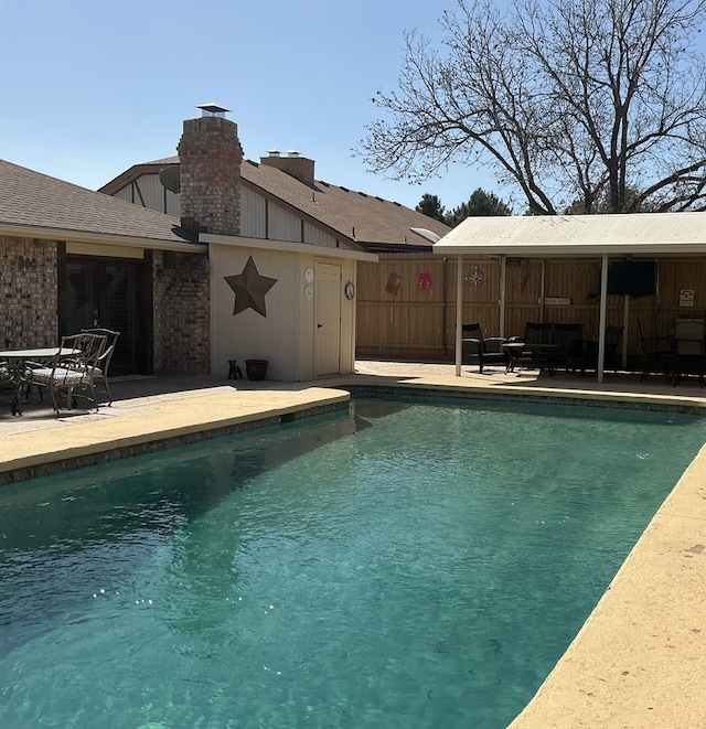 view of pool with a fenced in pool, a patio, and fence