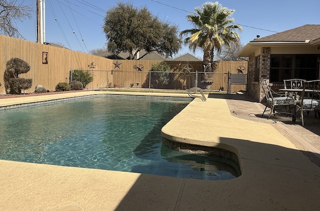 view of swimming pool featuring a patio, a fenced in pool, and a fenced backyard