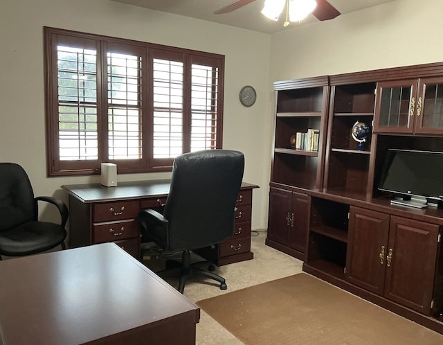 office featuring light carpet and a ceiling fan