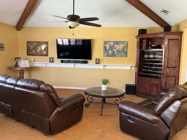 carpeted living room featuring lofted ceiling with beams, a ceiling fan, and visible vents