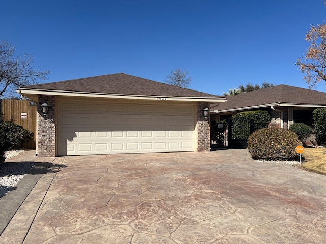 view of front of house with brick siding, a garage, driveway, and roof with shingles